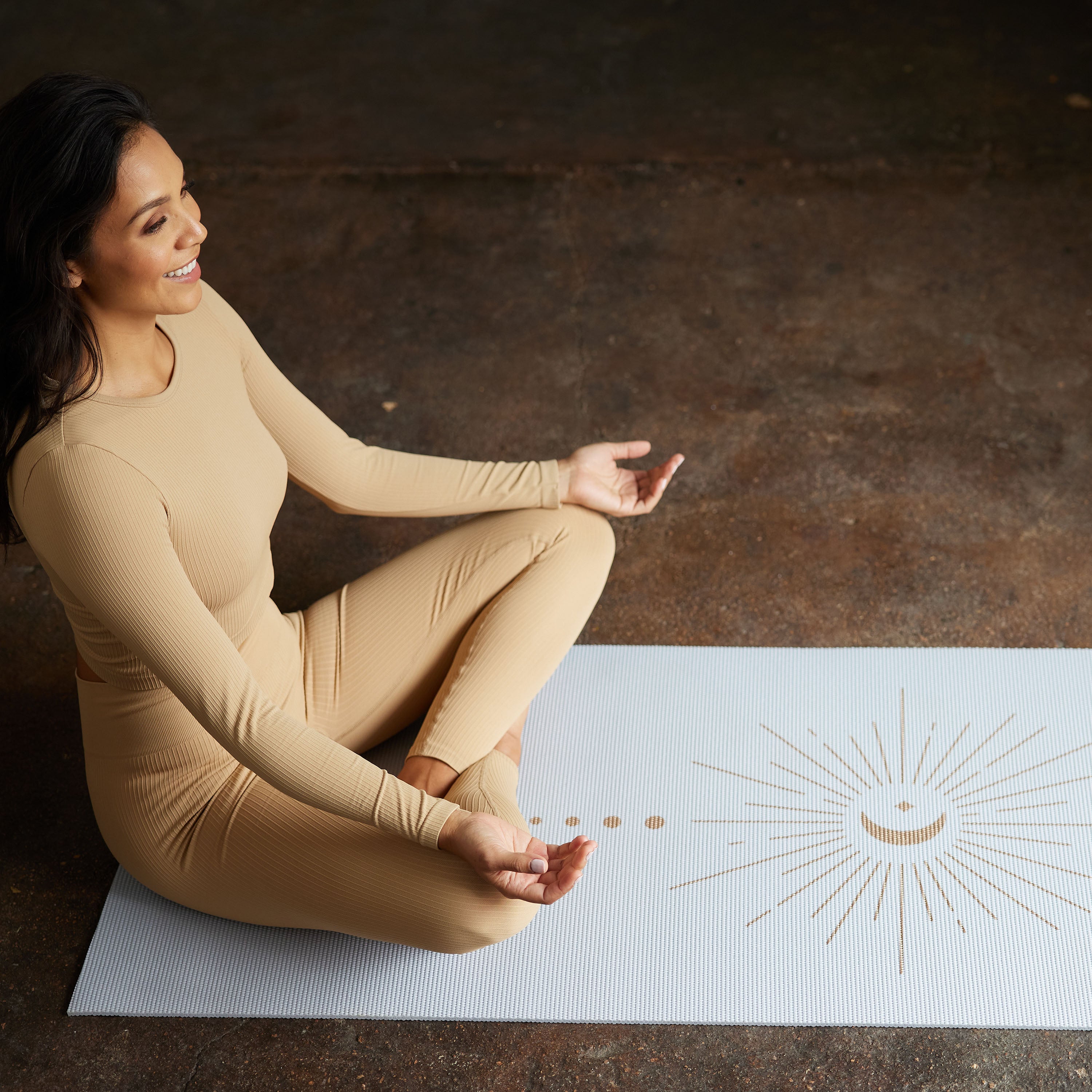 Person on yoga mat in Sukhasana pose